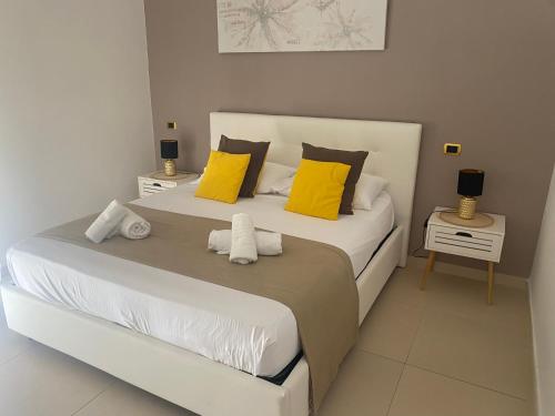 a bedroom with a large bed with yellow pillows at B&B Feni in Pompei