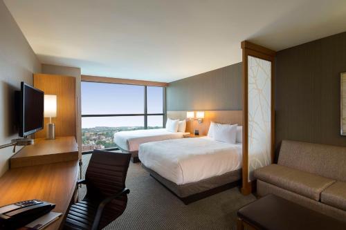 a hotel room with two beds and a couch at Hyatt Place Washington DC/US Capitol in Washington