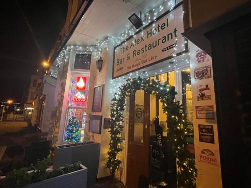 a building with christmas lights and a sign on it at The New Alexandra Hotel in Llandudno