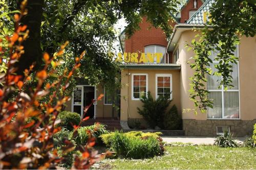 a house with a sign on the front of it at Pivdenna Brama in Khmelʼnytsʼkyy