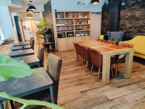 a dining room with a table and chairs at Hotel Ladeuze in Leuven