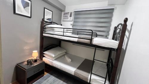 A bed or beds in a room at Urban Charms Seawind Condo, 5 mins to Davao Int'l Airport and Wharf to Samal Beach