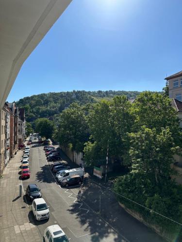 a street with cars parked in a parking lot at Double Bed Apartment - Near Marienplatz in Stuttgart