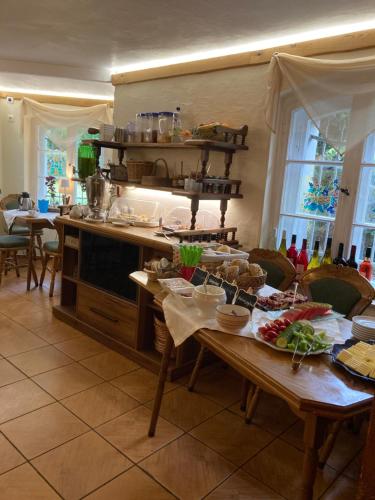 a kitchen with a table with food on it at Gast-& Logierhaus Am Rheinsberger See in Rheinsberg