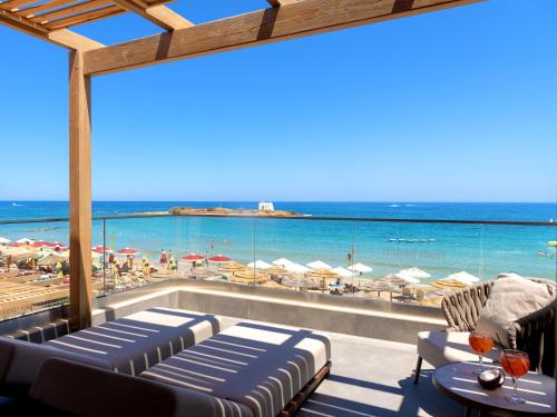 a view of the beach from the balcony of a resort at High Beach Resort in Malia