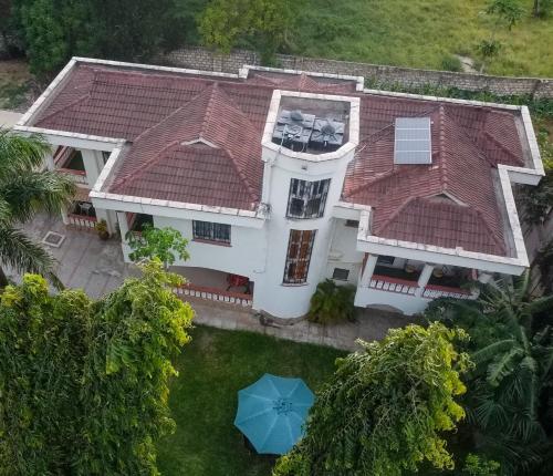 una vista aerea di una casa con ombrello blu di Mudzini gardens - Luxury villa with a pool a Mombasa