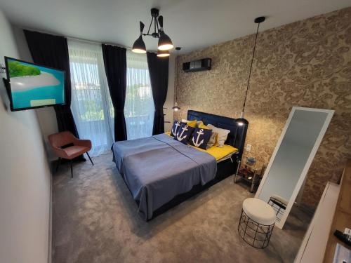 a bedroom with a bed and a flat screen tv at Sea view luxury appartment in Varna City