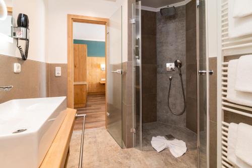 a bathroom with a shower and a sink at Hotel & Gasthof Richard Held in Regensburg