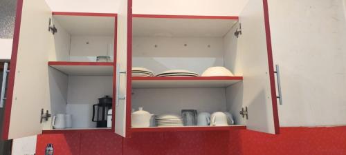 a cabinet with plates and dishes in it at PEPE´S HOUSE in Puno