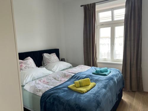 a bedroom with a bed with two yellow pillows on it at CityLife InApartment Salzburg in Salzburg