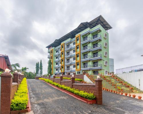 a building with a fence in front of it at Treebo Green Village Resort - Goa in Maneri