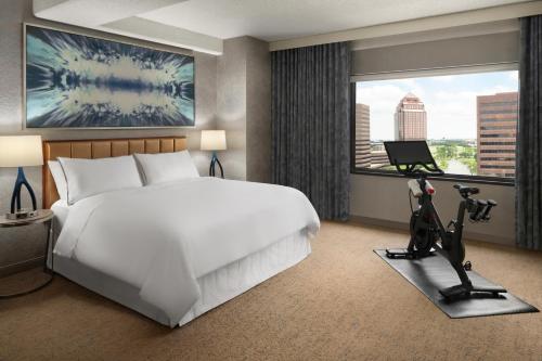 a hotel room with a bed and a large window at The Westin Chicago Northwest in Itasca