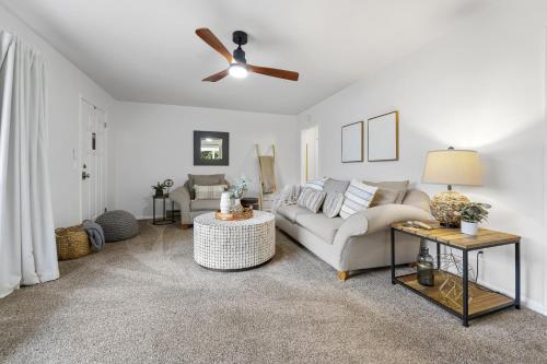 a living room with a couch and a ceiling fan at Sunrise - 1322 Indian Point Road in Branson