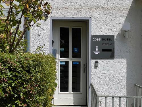 a door to a house with a sign on it at Weserstern in Bremen