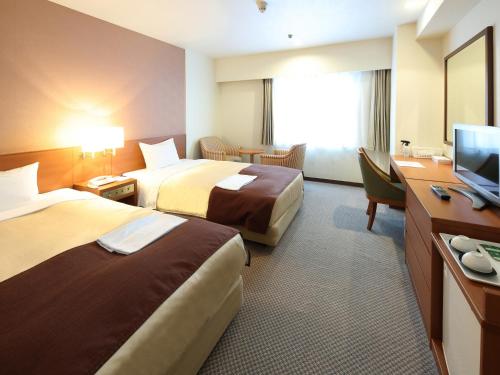 Tempat tidur dalam kamar di Hotel Pearl City Morioka