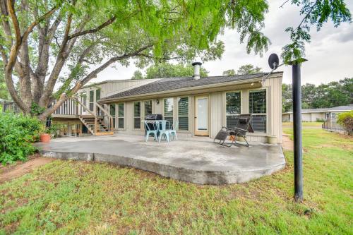 a house with a porch with a table and chairs at Remote Texas Retreat Hot Tub, Deck, Grill! in Dalhart