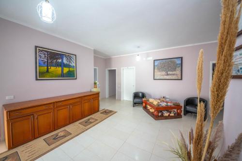 a large living room with a couch and avertisement at Blu Horizon Hotel Gjipe in Dhërmi