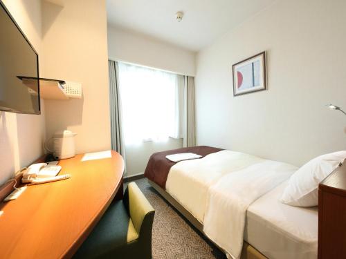 Tempat tidur dalam kamar di Hotel Pearl City Morioka