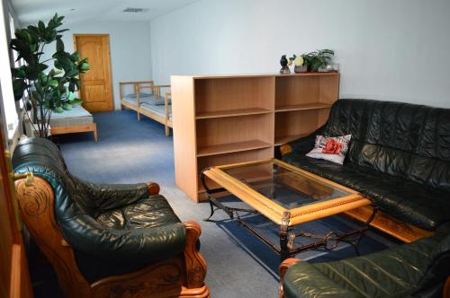 a living room with a couch and a coffee table at Guesthouse & sauna by HMTL in Liepāja