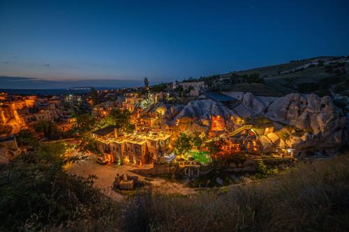 a view of a city at night with lights at Cappadocia Gamirasu Cave Hotel in Urgup