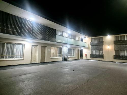 an empty parking lot in front of a building at night at Fawkner Executive Suites & Serviced Apartments in Melbourne