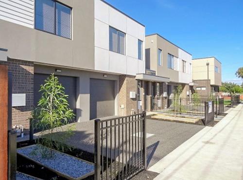 a building with a fence in front of it at Fawkner Executive Suites & Serviced Apartments in Melbourne