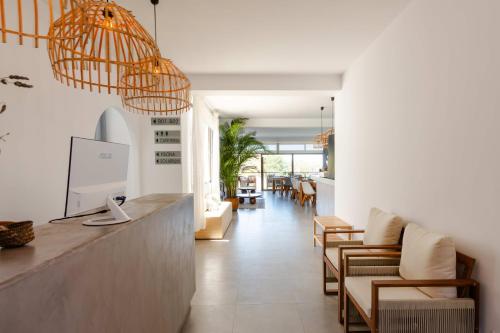 a lobby with chairs and a reception counter with lights at Victoria Sunset Suites in San Antonio