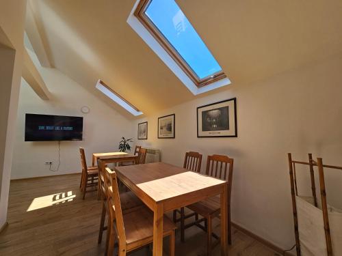 a dining room with two tables and a skylight at Leopold Chillout Hostel in Sarajevo