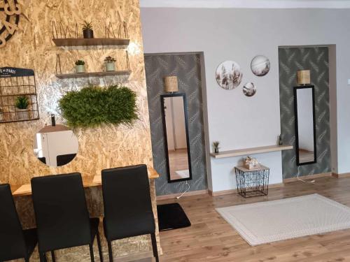 a room with three mirrors and a table and chairs at Apartman ClaRa in Štúrovo