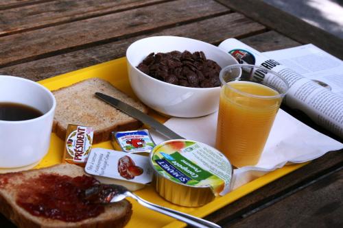 a tray with toast and coffee and a bowl of food at Class'eco Charleroi in Charleroi