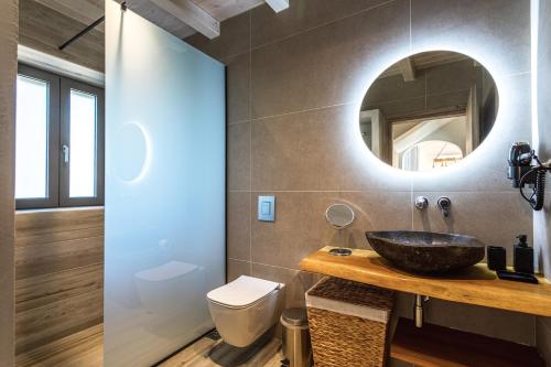 a bathroom with a sink and a mirror at Lakkos Villas in Kardamili