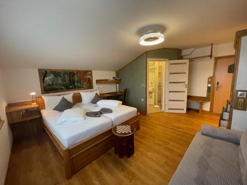 a bedroom with a large bed and a living room at Hotel Blumenbach in Berlin