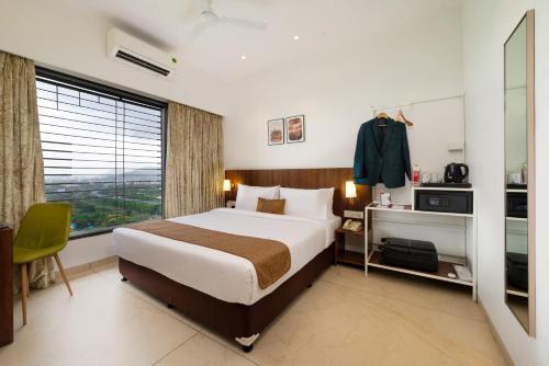 Rúm í herbergi á Freesia Residency By Express Inn - Navi Mumbai