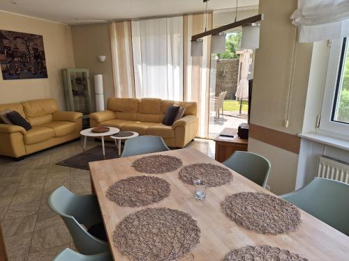 a living room with a table and chairs at Villa Feyen in Trier in Trier