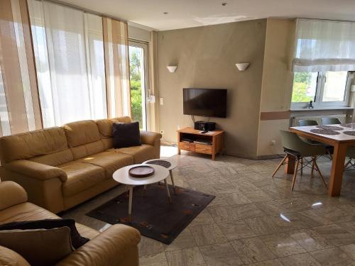 a living room with a couch and a table at Villa Feyen in Trier in Trier