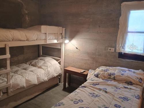 Una cama o camas en una habitación de Casa en Loma Pelada, Tafí del Valle ALQUILER MINIMO DOS NOCHES