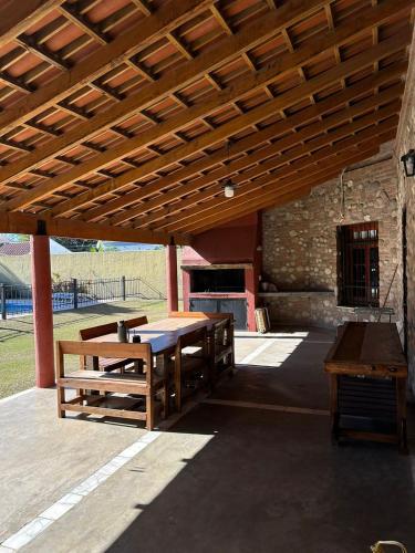 un patio avec une table et des bancs sous un toit en bois dans l'établissement Casa Arguello, à Córdoba