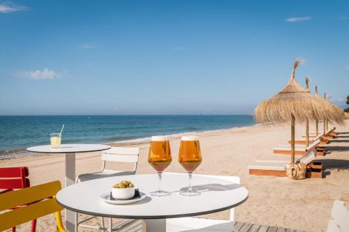 - deux verres de vin sur une table sur la plage dans l'établissement Estival Centurión Playa, à Cambrils