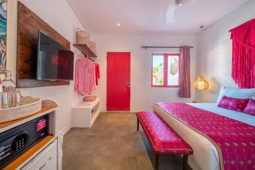 a bedroom with a bed and a red door at PinkPrivate Balangan - for Cool Adults Only in Jimbaran