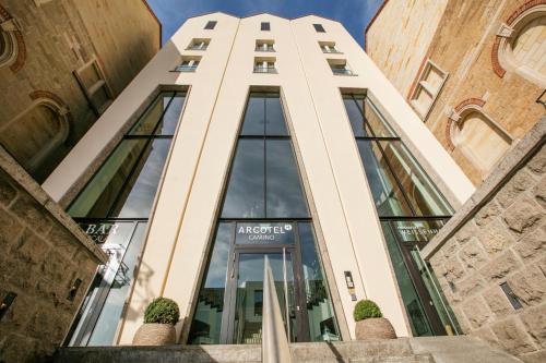 a tall building with a glass door at ARCOTEL Camino Stuttgart in Stuttgart