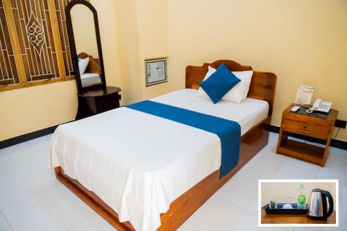 מיטה או מיטות בחדר ב-SP Tourist Hotel Jaffna