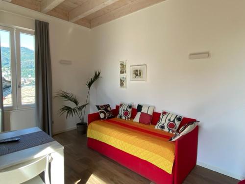 a bedroom with a bed with colorful pillows at Hotel Quarcino in Como