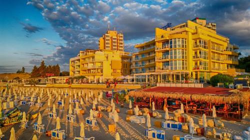 a group of beach chairs in front of a building at Perla Apartments First Line in Nesebar