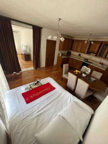 a living room with a white bed and a table at City Heart Apartments in Ulcinj