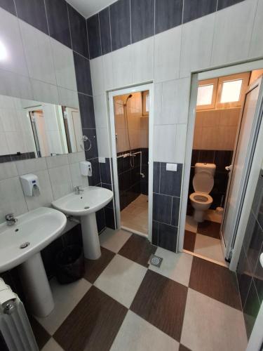 a bathroom with two sinks and a toilet at Guest house Vila Vedesa in Kotor