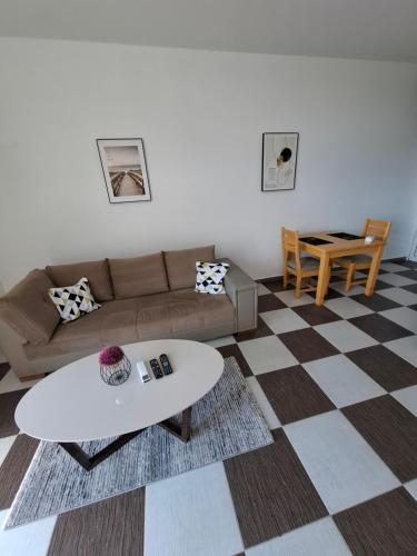 a living room with a couch and a table at Guest house Vila Vedesa in Kotor