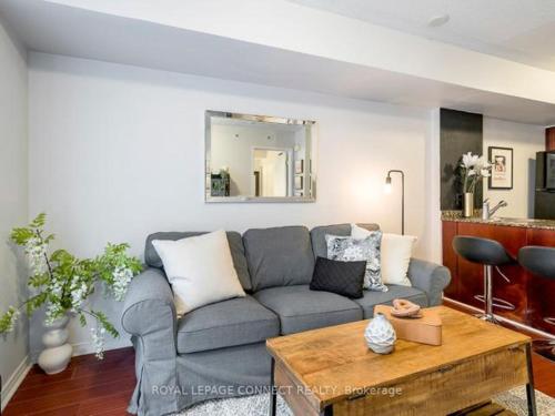 a living room with a couch and a table at Liberty Village Townhouse in Toronto