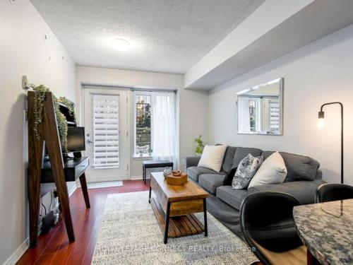 a living room with a couch and a table at Liberty Village Townhouse in Toronto