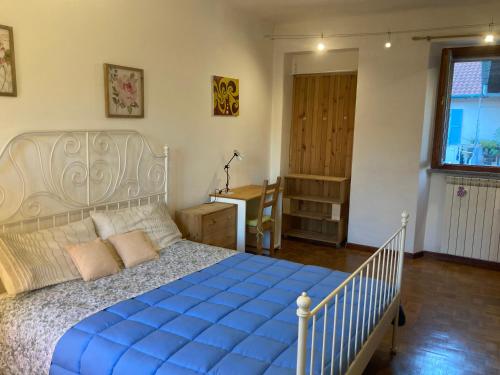 a bedroom with a large bed with a blue comforter at Casa Express tra Como e Milano in Saronno