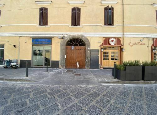 a building with a dog standing in front of a door at Charme Room&Relax in Torre del Greco